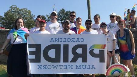 Group of individuals holding sign reading 