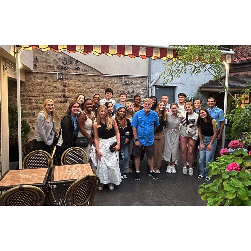 Hussman students and faculty at dinner in Paris