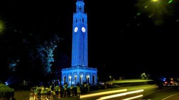 The Bell Tower lit up Carolina Blue at night.